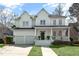 Charming two-story home featuring a welcoming front porch, manicured lawn, and attached two-car garage at 1749 James Basford Pl, Mount Pleasant, SC 29466