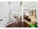 Elegant foyer showcasing a grand staircase, gleaming hardwood floors, and an open floor plan at 1749 James Basford Pl, Mount Pleasant, SC 29466