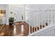 Inviting foyer with staircase, hardwood floors, and a view of the front door enhancing curb appeal at 1749 James Basford Pl, Mount Pleasant, SC 29466