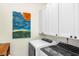 Bright laundry room with white cabinets and new washer and dryer at 1749 James Basford Pl, Mount Pleasant, SC 29466