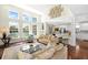 Bright living room boasts large windows, lake view, and hardwood floors at 1749 James Basford Pl, Mount Pleasant, SC 29466