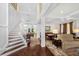 Spacious living room boasts a high ceiling, staircase, and hardwood floors offering a grand and inviting space at 1749 James Basford Pl, Mount Pleasant, SC 29466