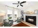 Bright office with a fireplace, built-in shelves and a view of the backyard at 1749 James Basford Pl, Mount Pleasant, SC 29466