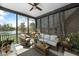Screened-in porch with ceiling fan and comfortable seating overlooking a serene lake at 1749 James Basford Pl, Mount Pleasant, SC 29466