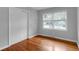 Bright bedroom featuring hardwood floors, closet, and a window with natural light at 1785 N Mayflower Dr, Charleston, SC 29412