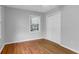 Bedroom with hardwood flooring, a window offering natural light, and closet at 1785 N Mayflower Dr, Charleston, SC 29412
