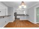 Open concept dining area featuring hardwood floors and modern lighting with view into the kitchen at 1785 N Mayflower Dr, Charleston, SC 29412