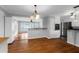 Inviting dining area offering hardwood floors, neutral walls, modern lighting, and open to living spaces at 1785 N Mayflower Dr, Charleston, SC 29412