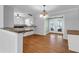Well-lit dining area featuring hardwood floors, modern lighting fixtures, and open view into kitchen at 1785 N Mayflower Dr, Charleston, SC 29412