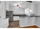 Modern kitchen featuring white cabinets, stainless steel appliances, and a stylish breakfast bar at 1785 N Mayflower Dr, Charleston, SC 29412