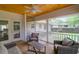 Cozy screened-in porch with furniture and wood flooring overlooking the backyard at 1785 N Mayflower Dr, Charleston, SC 29412