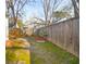 Backyard with grass, mulch, and a tall wooden fence at 1906 Cedar Petal Ln, Charleston, SC 29414