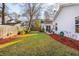 Lush backyard with a green lawn, mulched beds, and access to the home's rear entrance at 1906 Cedar Petal Ln, Charleston, SC 29414