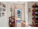 Inviting entryway featuring hardwood floors, a red front door, and stylish shelving for storage and decor at 1906 Cedar Petal Ln, Charleston, SC 29414