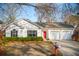Charming single-story home featuring a red front door, attached garage, and well-maintained landscaping at 1906 Cedar Petal Ln, Charleston, SC 29414