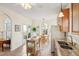 Bright kitchen featuring stainless steel appliances, an island and an adjacent dining area with access to backyard at 1906 Cedar Petal Ln, Charleston, SC 29414
