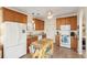 Well-equipped kitchen with wooden cabinets, granite countertops, and a functional kitchen island at 1906 Cedar Petal Ln, Charleston, SC 29414