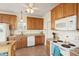 Traditional-style kitchen with wooden cabinets, white appliances, and a ceiling fan at 1906 Cedar Petal Ln, Charleston, SC 29414