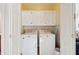 Clean laundry room with white washer, dryer, and cabinets above at 1906 Cedar Petal Ln, Charleston, SC 29414