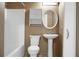 A neutral bathroom with a toilet, sink, mirror, and shower-tub combo at 2 Leone Ln, Hanahan, SC 29410