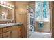 Neutral bathroom with a window bringing in light, vanity, and a shower with a striped curtain at 2 Leone Ln, Hanahan, SC 29410