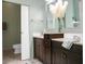 Bathroom with dark vanity, double sinks, and modern fixtures at 2 Leone Ln, Hanahan, SC 29410