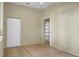 Bright bedroom with wood floors, ceiling fan, and a doorway to an arched alcove with built-in shelving at 2 Leone Ln, Hanahan, SC 29410