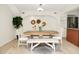 Dining room with stylish white chairs, a modern table, and bright natural light at 2 Leone Ln, Hanahan, SC 29410