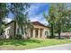 Traditional home featuring a columned portico entrance, shutters, and mature landscaping at 2 Leone Ln, Hanahan, SC 29410