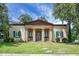 Stately home featuring a columned portico entrance, shutters, and lush lawn at 2 Leone Ln, Hanahan, SC 29410