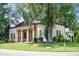 Traditional home featuring a columned portico entrance, shutters, and mature landscaping at 2 Leone Ln, Hanahan, SC 29410