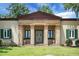 Traditional home featuring a columned portico entrance, shutters, and manicured lawn at 2 Leone Ln, Hanahan, SC 29410