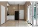 Bright living room with wood floors, a black refrigerator, and arched doorways leading outside at 2 Leone Ln, Hanahan, SC 29410
