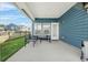 Back porch of a blue house, complete with outdoor seating, creating an ideal space for relaxing and entertaining at 202 Morning Song St, Summerville, SC 29485