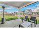 Inviting back porch with patio furniture, offering a perfect outdoor relaxation area overlooking the yard at 202 Morning Song St, Summerville, SC 29485