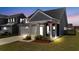 Charming home featuring gray siding, a cozy front porch, and well-maintained landscaping at 202 Morning Song St, Summerville, SC 29485