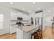 Bright kitchen features granite counters, stainless appliances, and a central island with seating at 202 Morning Song St, Summerville, SC 29485