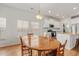 Open layout shows the kitchen and its stainless steel appliances from the dining area at 202 Morning Song St, Summerville, SC 29485