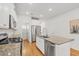 Well-lit kitchen featuring an island, stainless steel appliances, and granite countertops at 202 Morning Song St, Summerville, SC 29485