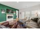 Inviting living room with a fireplace and green accent wall at 202 Morning Song St, Summerville, SC 29485