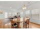 Open concept living and dining areas filled with natural light from large windows at 202 Morning Song St, Summerville, SC 29485