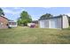 Expansive backyard features a metal shop with two roll-up doors, offering ample storage and workspace at 217 Mini Farm Rd, Bonneau, SC 29431