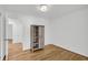 Well-lit bedroom featuring beautiful hardwood floors, neutral walls, and a rustic wooden storage cabinet at 217 Mini Farm Rd, Bonneau, SC 29431