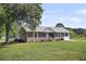Charming brick home features a metal roof, tidy landscaping, and a spacious front yard at 217 Mini Farm Rd, Bonneau, SC 29431