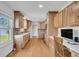 Spacious kitchen showcasing wooden cabinets, a brick backsplash, and hardwood floors at 217 Mini Farm Rd, Bonneau, SC 29431
