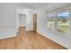 Inviting living room featuring hardwood floors, neutral walls, windows and a doorway to another room at 217 Mini Farm Rd, Bonneau, SC 29431