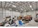 Interior view of a large outbuilding featuring multiple vehicles, tools, and equipment at 217 Mini Farm Rd, Bonneau, SC 29431
