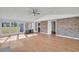 Bright sunroom featuring neutral walls, tile floors, many windows with backyard views, and a brick accent wall at 217 Mini Farm Rd, Bonneau, SC 29431