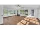 Bright sunroom featuring neutral walls, tile floors, many windows with backyard views, and a ceiling fan at 217 Mini Farm Rd, Bonneau, SC 29431