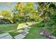 Spacious backyard with lush greenery, a stone pathway, and a peaceful outdoor setting at 22 Ashton St, Charleston, SC 29403